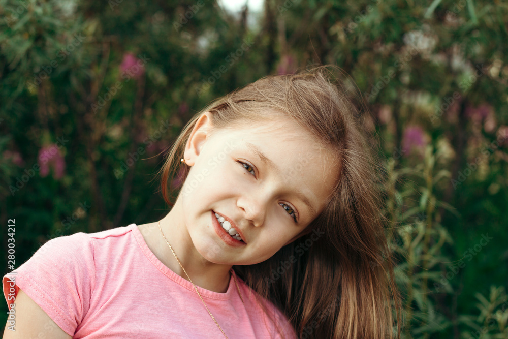 beautiful happy healthy little girl portrait in a summer garden beautiful happy healthy little girl portrait in a summer garden