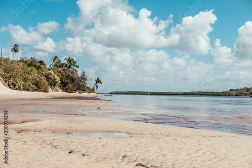 paradise beach without people with hills and palm trees