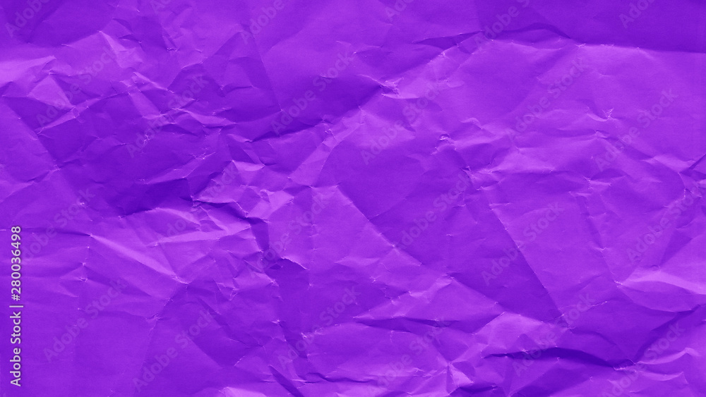 Crumpled sheet of purple color paper texture background