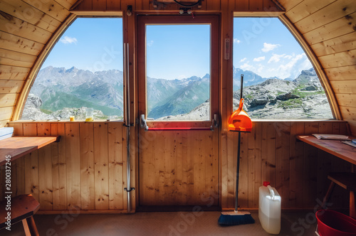 Interior of the longet pass olivero mountain bivouac (free sleeping shelter) in the piedmontese alps (Italy), facing the famous peak of Monviso (Mount Viso) photo