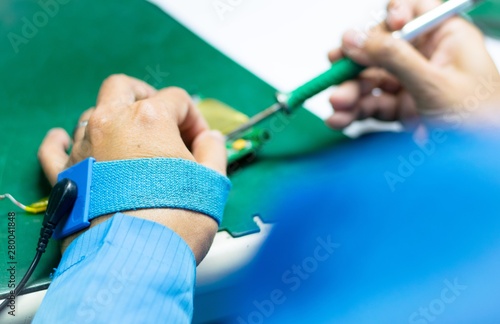 Technician use wrist strap for ESD protection in work area photo