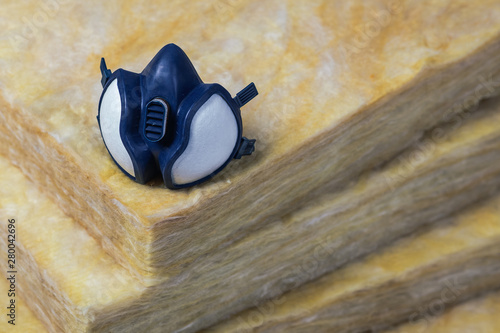 Gas mask sitting on top of some mineral wool rockwool (stonewool) panels (dark version) top photo