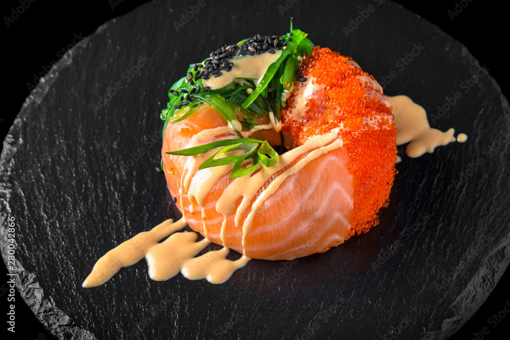 Sushi donuts from rice with salmon, smoked eel, tuna, caviar, avocado and cucumber. Sushi menu. Japanese food. Sushi donuts from rice with salmon, smoked eel, tuna, caviar, avocado and cucumber. Sushi menu. Japanese food.