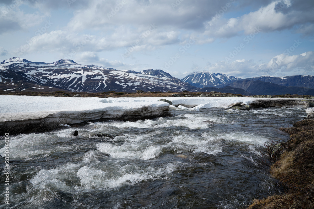 Wild lowing water in the icy mountains of Norway's Jotenheimer. 