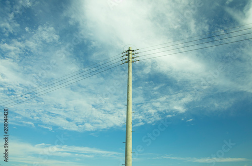 utility pole on blue cloudy sky