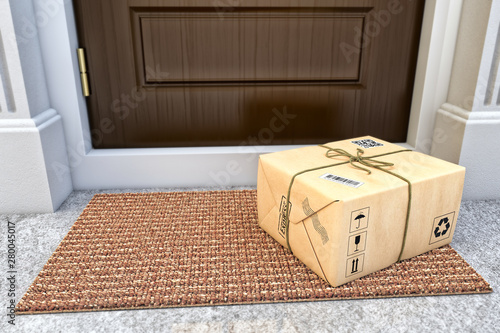 Express package delivery service concept, parcel box wrapped in craft paper on the door mat near the entrance door