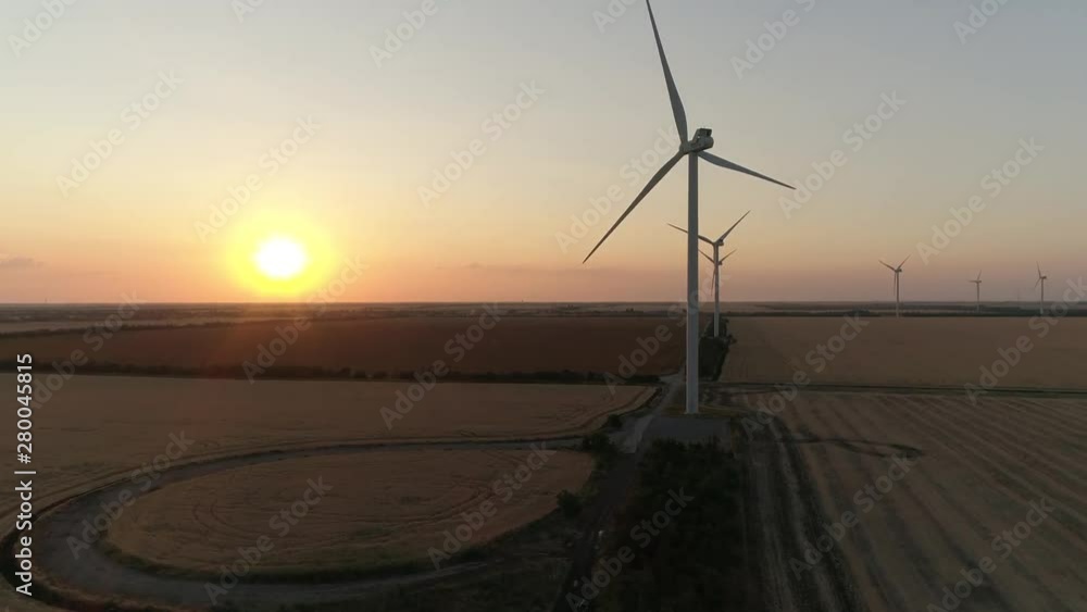 Aerial view of Wind turbines Energy Production - 4k aerial shot on sunset. 4k drone footage turbines at sunrise Aerial view of Wind turbines Energy Production - 4k aerial shot on sunset. 4k drone footage turbines at sunrise