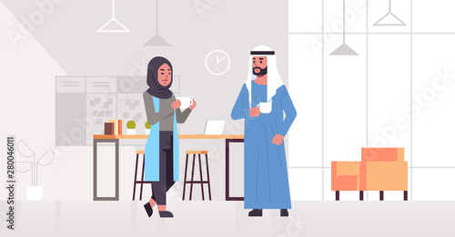 arabic businesspeople couple drinking cappuccino arab business man woman discussing during meeting coffee break concept modern office lounge area interior full length horizontal