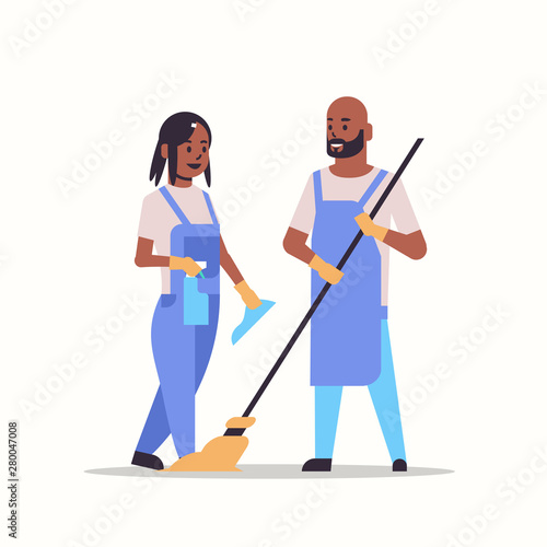 couple man woman in uniform cleaning service concept african american cleaners holding mop and spray plastic bottle working together full length flat