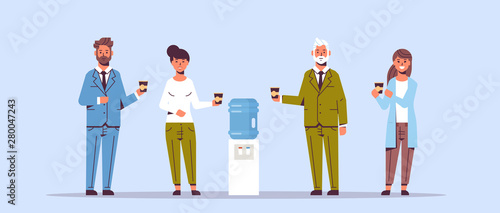 businesspeople office workers talking and drinking water while standing near cooler employees having break concept flat full length horizontal