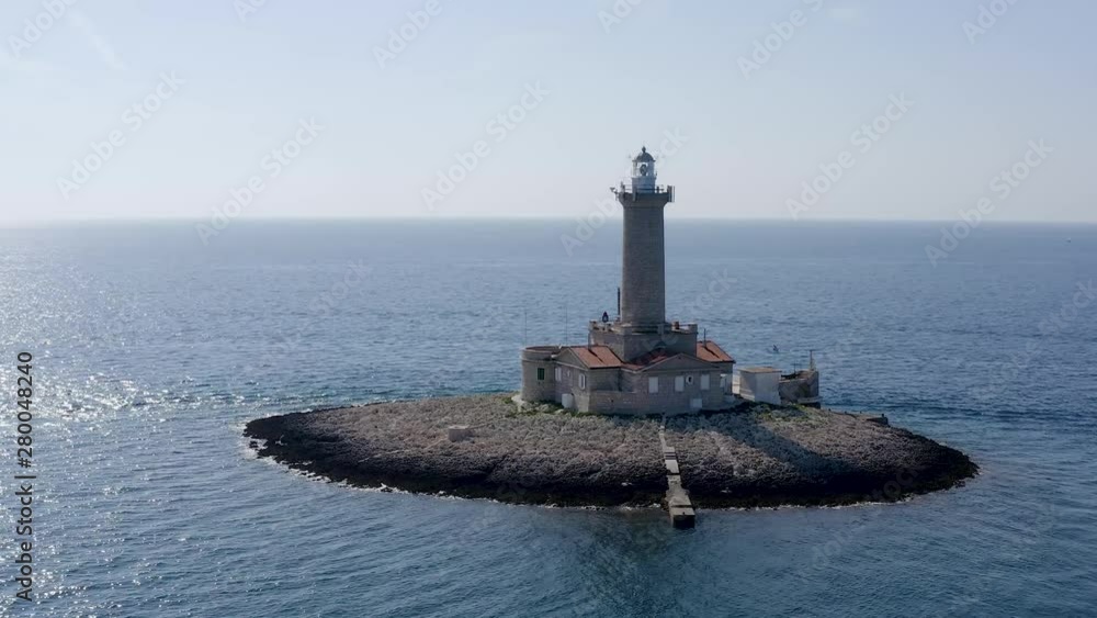 DRONE slowly circling a lighthouse on a tiny island off the coast of Croatia DRONE slowly circling a lighthouse on a tiny island off the coast of Croatia