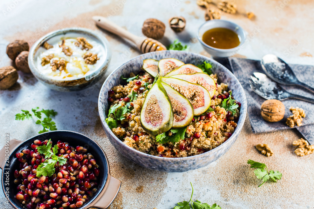 close-up view of tasty healthy couscous salat with figs fruits, nuts and pomegranate seeds close-up view of tasty healthy couscous salat with figs fruits, nuts and pomegranate seeds