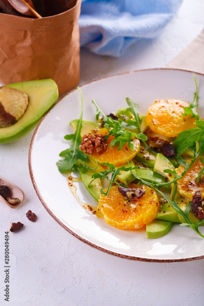 fresh avocado and orange salad on a beige plate fresh avocado and orange salad on a beige plate