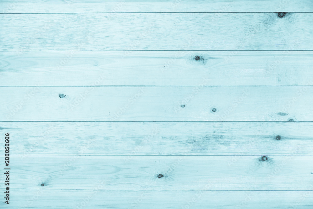 Naklejka premium Light blue neon wooden background made of natural wood. The view from the top. Natural untreated planed texture of the rocks of the pine. The surface of the table to shoot flat lay. Copy paste