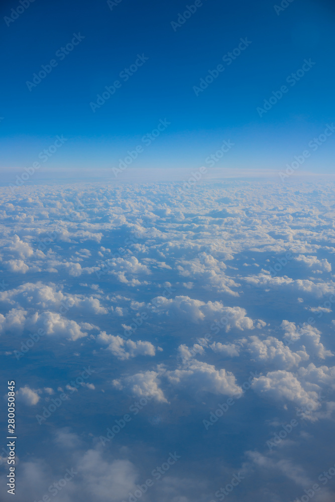 Sky and clouds from above the ground viewed from an airplane Sky and clouds from above the ground viewed from an airplane