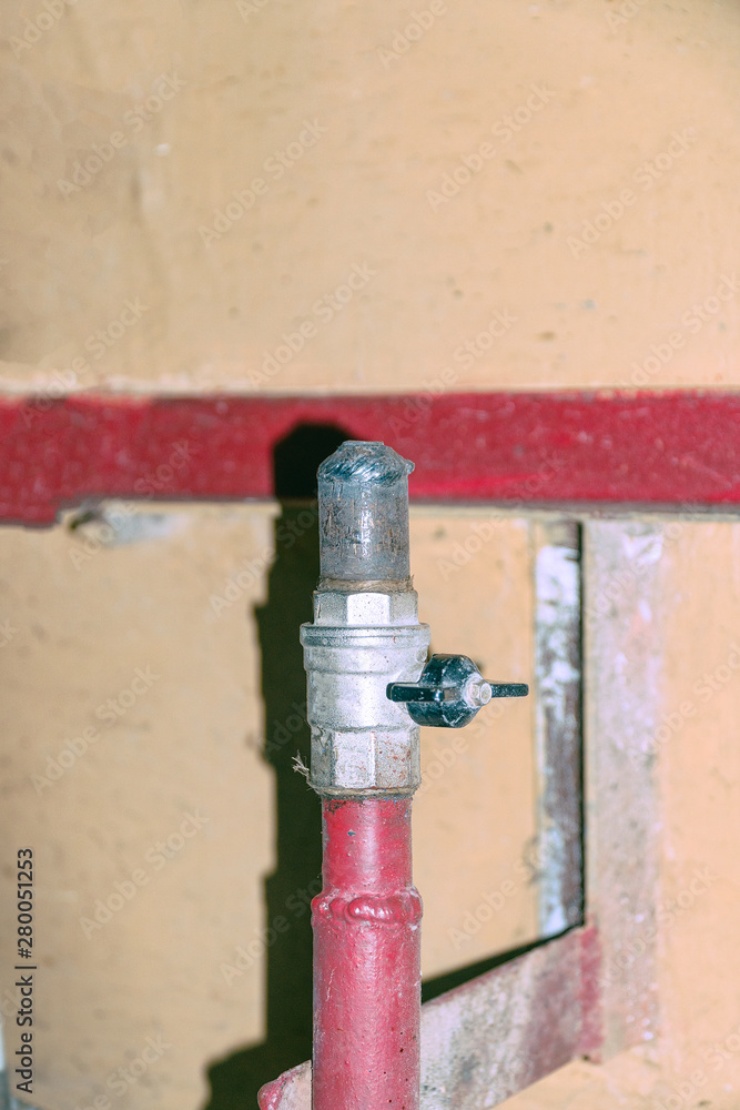 Tap the plug on a metal pipe of water supply Tap the plug on a metal pipe of water supply