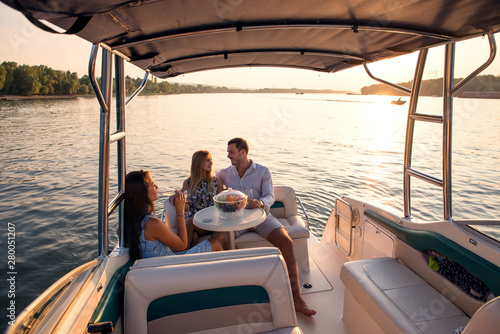 Sunset on a boat, friends are enjoying