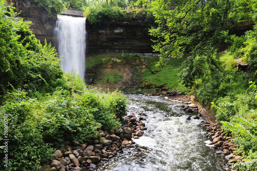 Beautiful summer nature background with flowing water. Scenic landscape with waterfall in the Minnehaha Park, Minneapolis, Minnesota, USA. photo