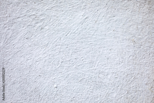Old, white, cement stone plastered and textured concrete wall. Background wallpaper.