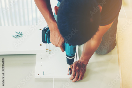 Photography Service man assembling furniture for customer, Delivery service furniture store and assembling for buyer