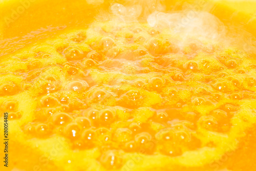 texture of yellow boiling jam  similar to lava and sun