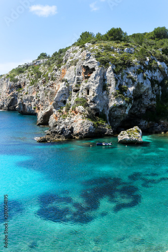 Crystal sea water with wild cliffs in Cales Coves, Menorca, Balearic Islands. Spain