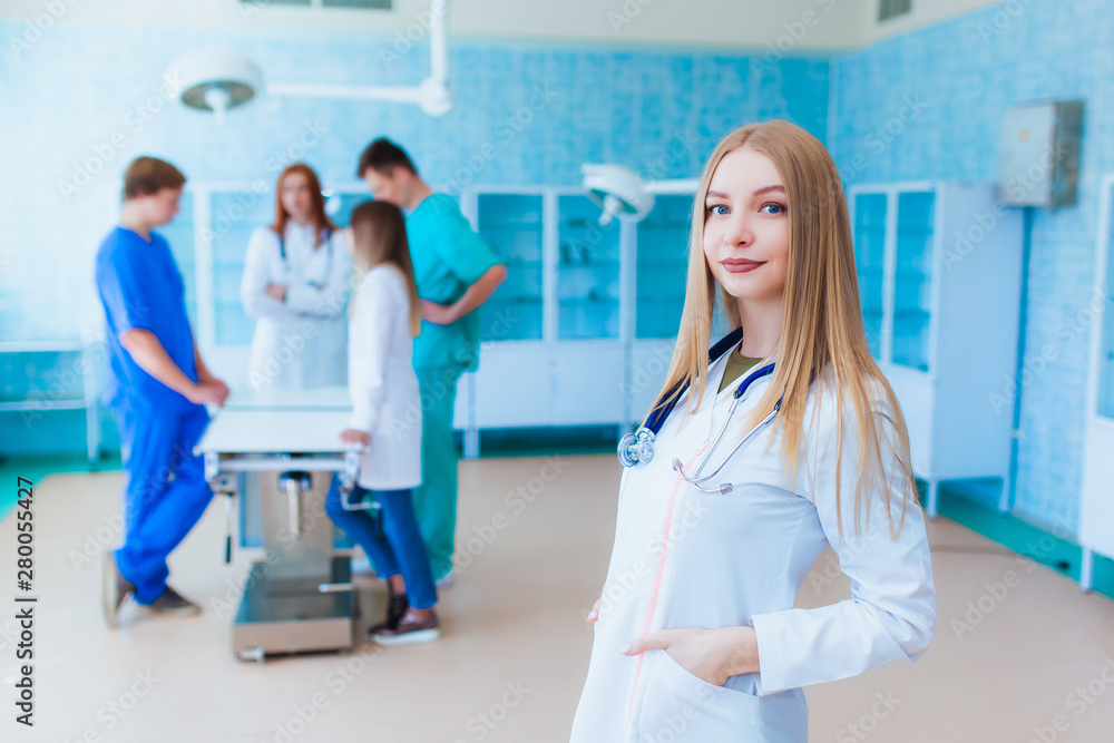 Portrait of a doctor intern. Medical students profession staff. multinational people - doctor, nurse and surgeon. A group of graduates of a medical university in a surgical room. Portrait of a doctor intern. Medical students profession staff. multinational people - doctor, nurse and surgeon. A group of graduates of a medical university in a surgical room.