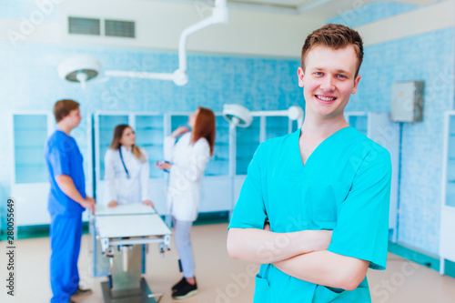 Portrait of a doctor intern. Medical students profession staff. multinational people - doctor, nurse and surgeon. A group of graduates of a medical university in a surgical room.