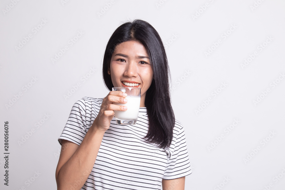 Healthy Asian woman drinking a glass of milk. Healthy Asian woman drinking a glass of milk.