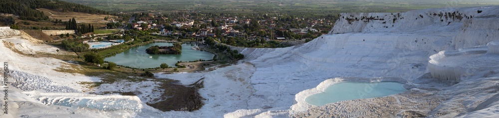 Fototapeta premium Turkey, aerial view of the travertine terraces at Pamukkale (Cotton Castle), natural site of sedimentary rock deposited by water from hot springs, famous for carbonate mineral left by flowing water