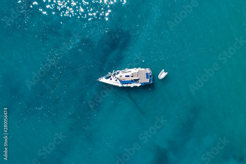Aerial view of a boat on water and sandy coastline view © magdal3na