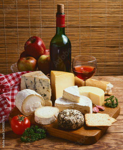 Assorted cheese on a wooden board.