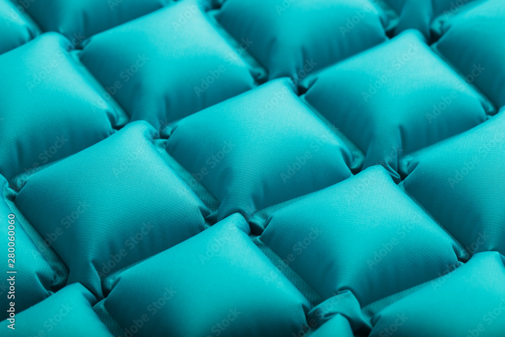Fototapeta premium Texture of a blue inflatable tourist rug, repeating sections and patterns. Air mattress Ultralight Portable rug.