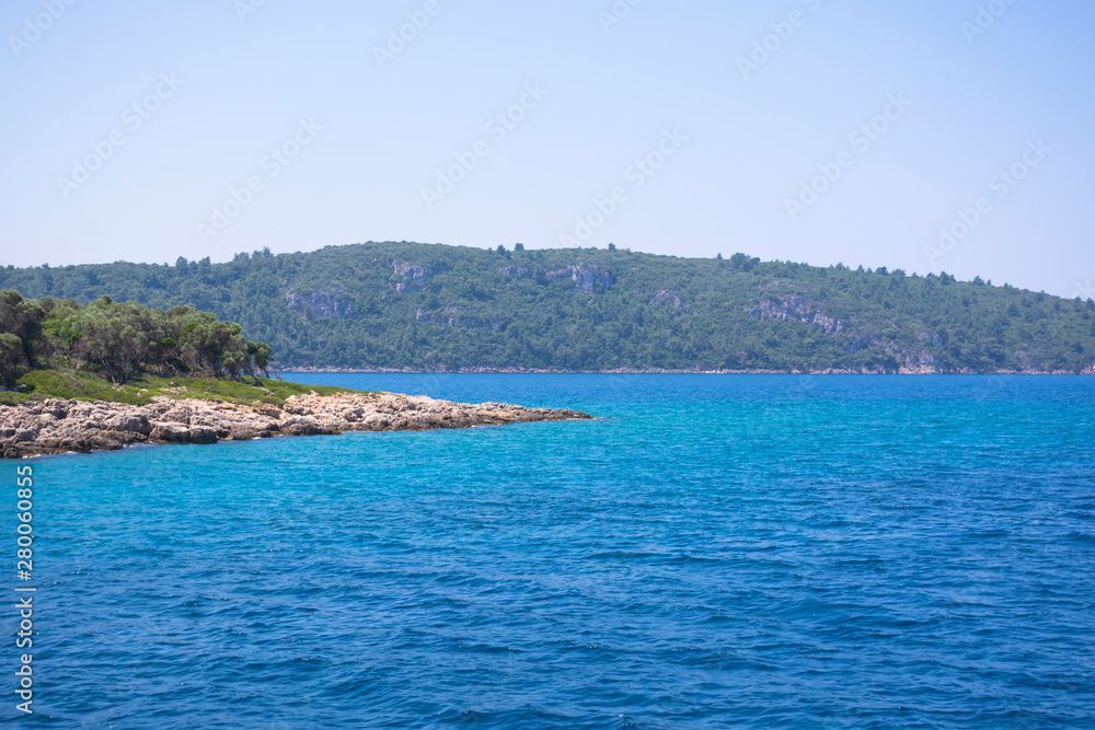 Aegean Islands on mountains and blue sky background, Turkey. Tropical wallpaper, paradise beach