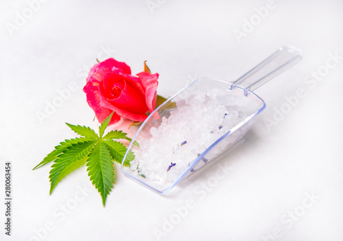 Cannabis infused bath salts with marijuana leaf and rose bud photo