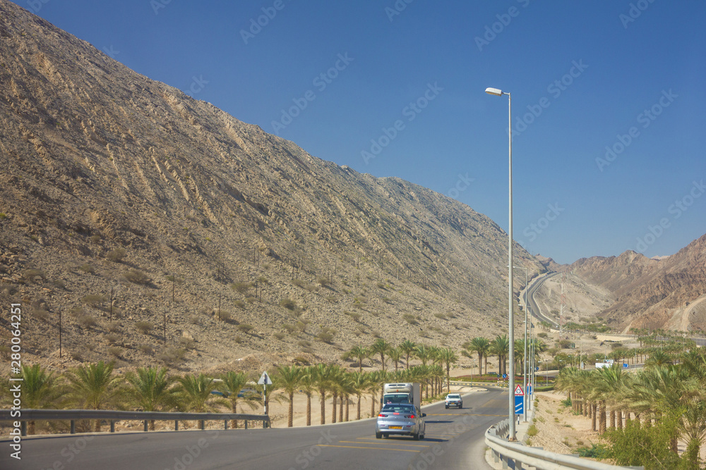 Oman: Automobiles on Muscat mountain road.