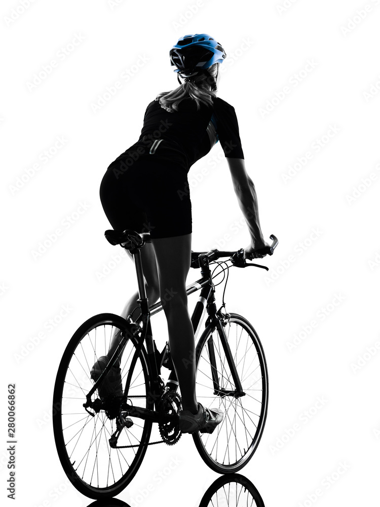 Fototapeta premium one caucasian cyclist woman cycling riding bicycle in silhouette isolated on white background rear view