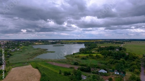Wallpaper Mural Ukrainian village on the lake with the eyes of a bird. Drone flies over the lake and nearby are private houses in the village. Summer, cloudy weather. Torontodigital.ca