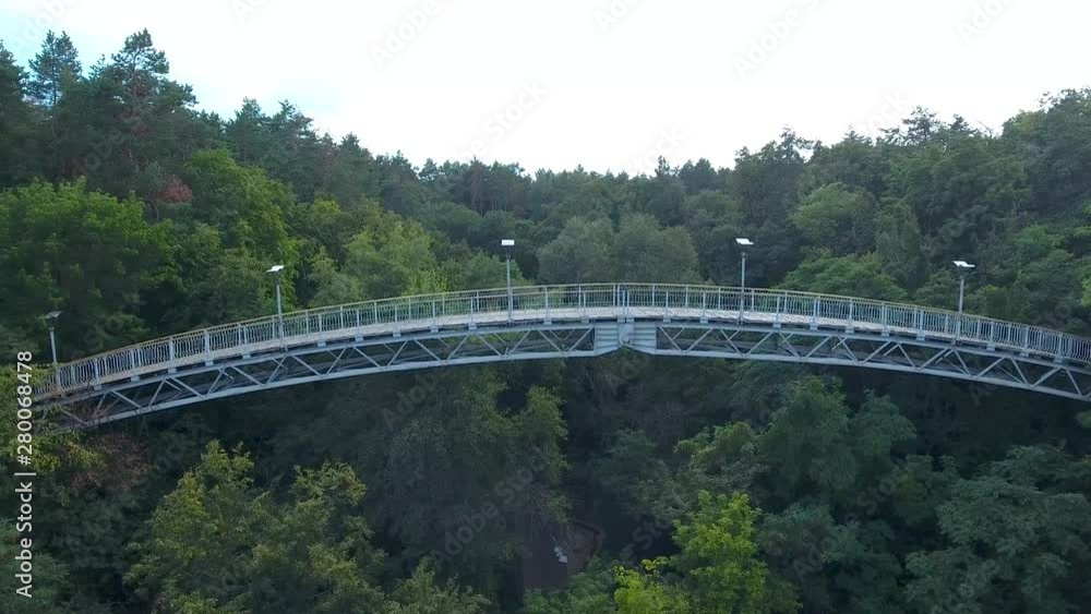 Bridge of love from a bird's eye view in the city of Cherkasy. Drone flies near the bridge over the gorge near the Dnieper River. Bridge of love from a bird's eye view in the city of Cherkasy. Drone flies near the bridge over the gorge near the Dnieper River.