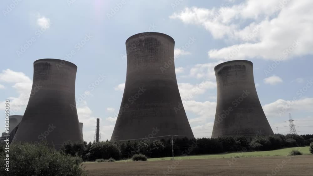 Power station cooling towers in agricultural landscape. Low aerial looking up to top of chimneys. Dolly left. Power station cooling towers in agricultural landscape. Low aerial looking up to top of chimneys. Dolly left.