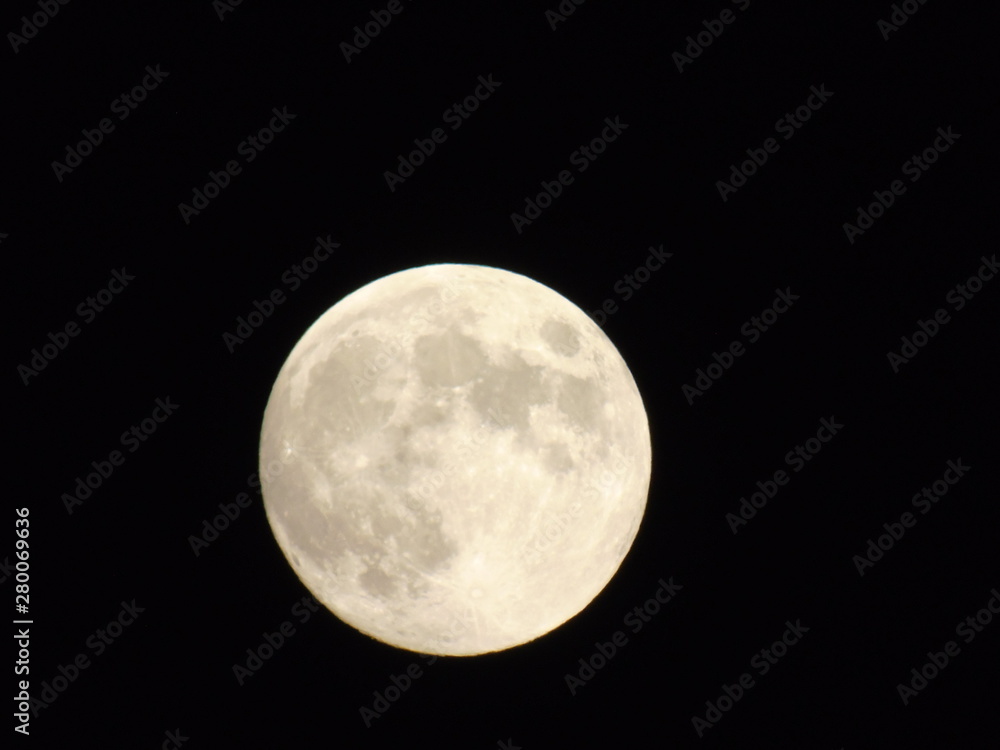 An amazing photography of the full moon over the city of Genova by night with a great clear sky in background and some stars An amazing photography of the full moon over the city of Genova by night with a great clear sky in background and some stars