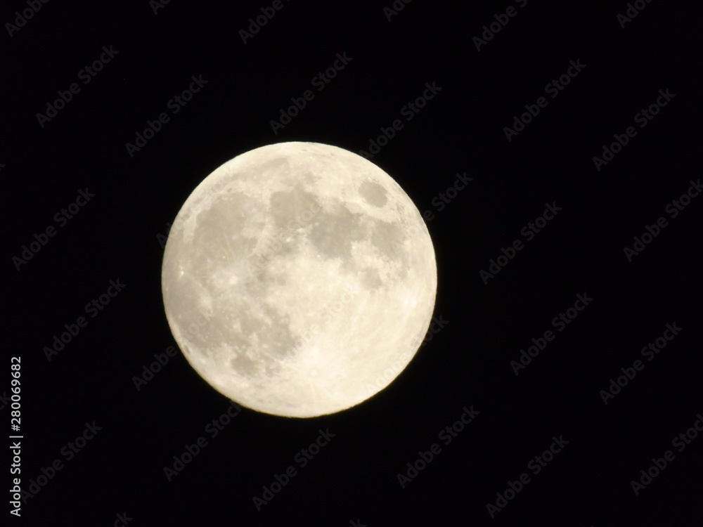 An amazing photography of the full moon over the city of Genova by night with a great clear sky in background and some stars An amazing photography of the full moon over the city of Genova by night with a great clear sky in background and some stars
