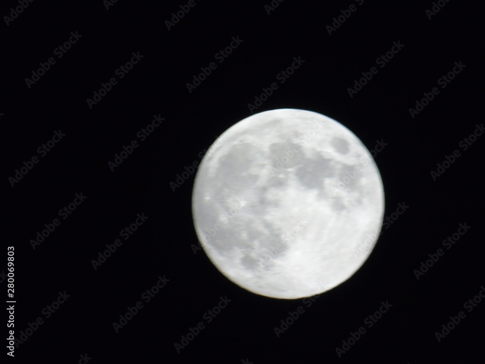 An amazing photography of the full moon over the city of Genova by night with a great clear sky in background and some stars An amazing photography of the full moon over the city of Genova by night with a great clear sky in background and some stars