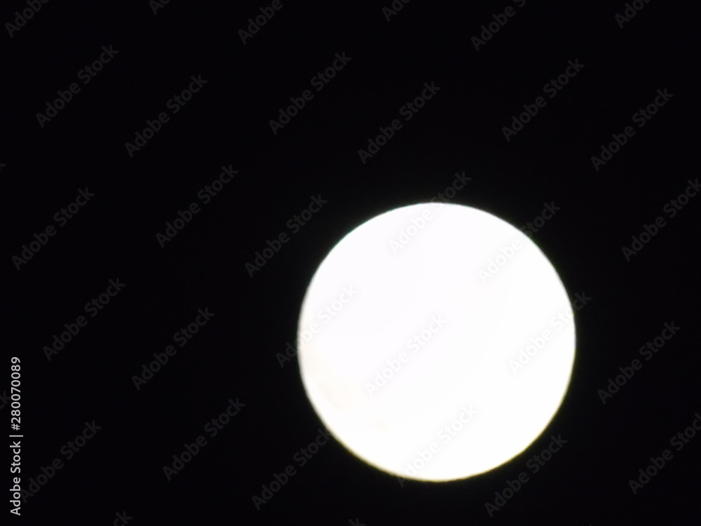 An amazing photography of the full moon over the city of Genova by night with a great clear sky in background and some stars An amazing photography of the full moon over the city of Genova by night with a great clear sky in background and some stars