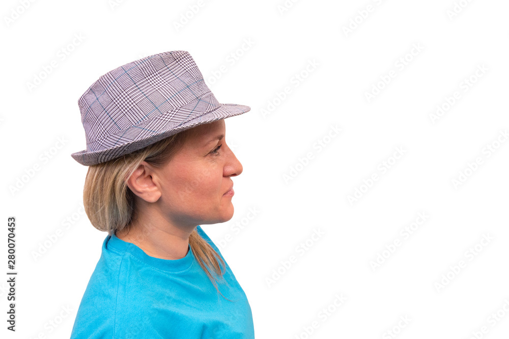 Girl in hat. White middle aged woman looks away and smiles. Profile portrait with positive face Girl in hat. White middle aged woman looks away and smiles. Profile portrait with positive face