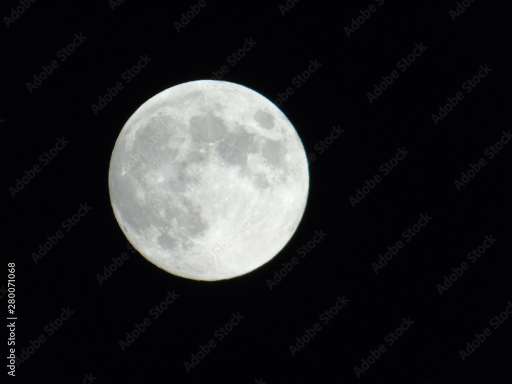 An amazing photography of the full moon over the city of Genova by night with a great clear sky in background and some stars An amazing photography of the full moon over the city of Genova by night with a great clear sky in background and some stars