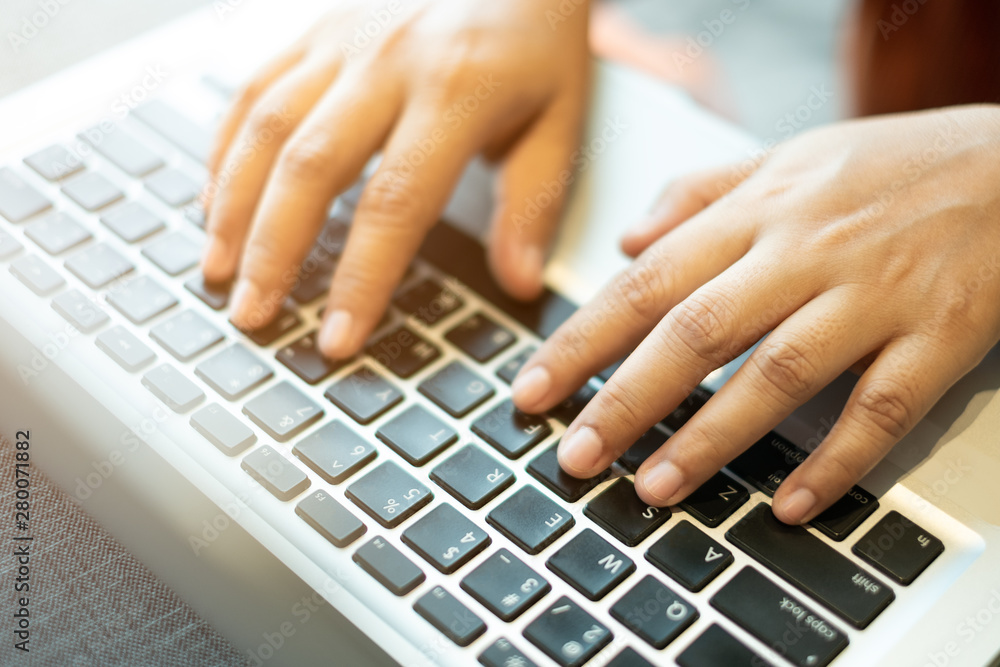 hands typing on a notebook keyboard. selective, soft focus hands typing on a notebook keyboard. selective, soft focus