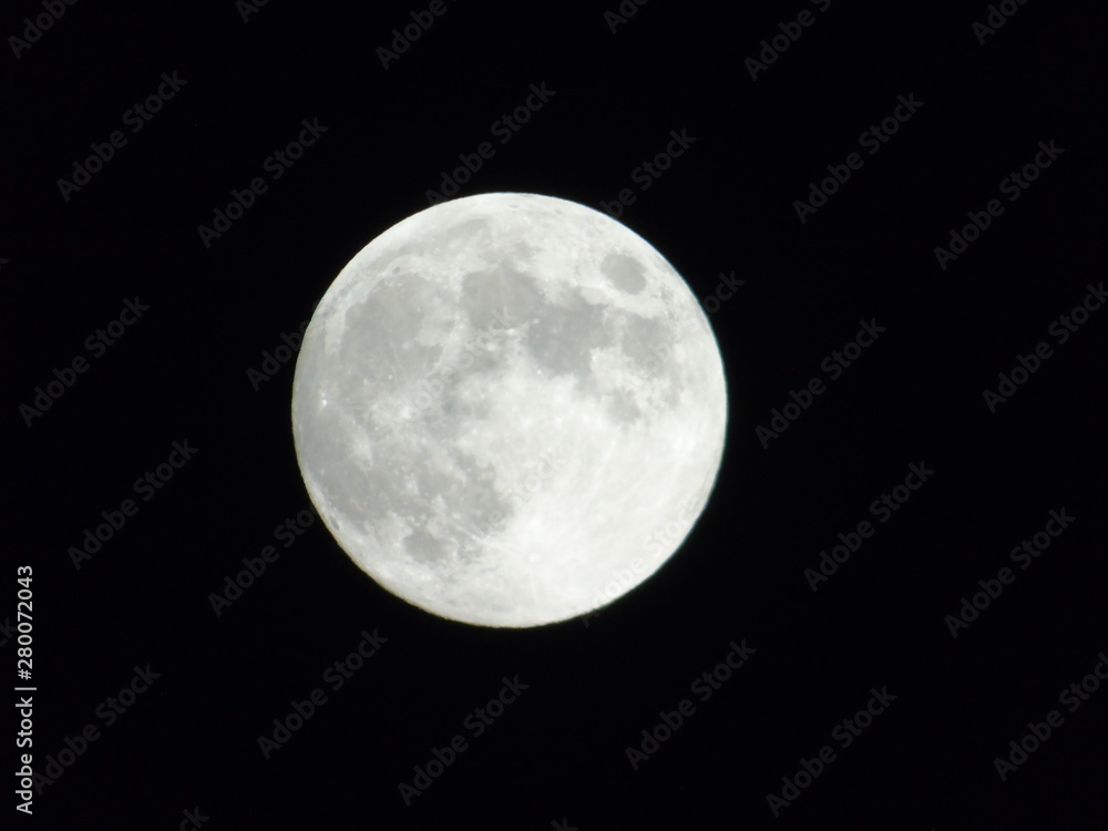 An amazing photography of the full moon over the city of Genova by night with a great clear sky in background and some stars An amazing photography of the full moon over the city of Genova by night with a great clear sky in background and some stars
