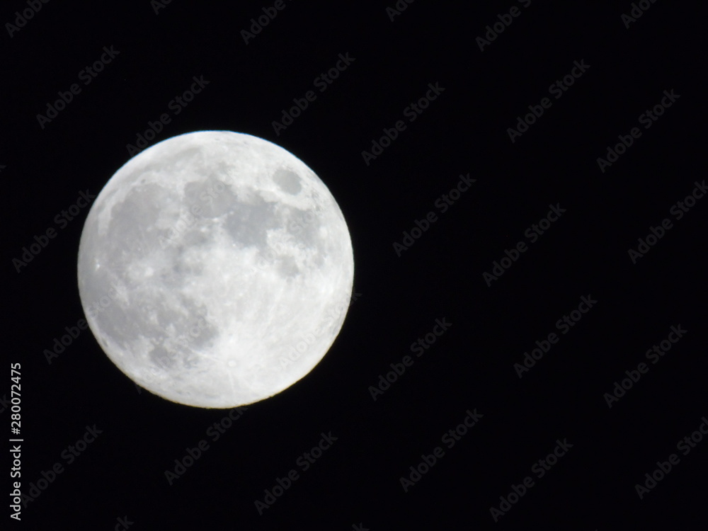 An amazing photography of the full moon over the city of Genova by night with a great clear sky in background and some stars An amazing photography of the full moon over the city of Genova by night with a great clear sky in background and some stars