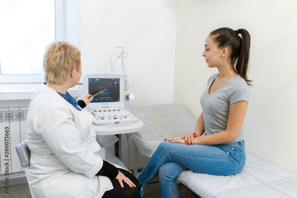 Professional doctor advises the patient young girl after ultrasound Professional doctor advises the patient young girl after ultrasound
